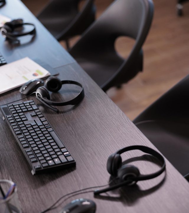 empty-helpdesk-office-with-telephony-equipment-reception-give-assistance-no-people-telemarketing-space-customer-service-client-support-remote-helpline-headphones